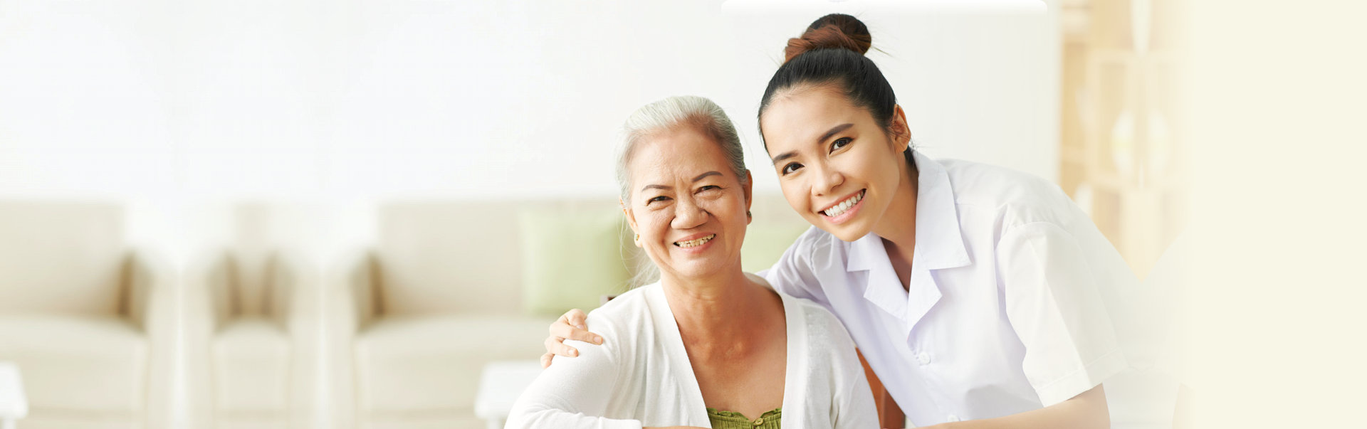 caregiver and senior woman are smiling at the house