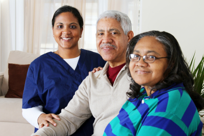 caregiver and couple senior are smiling