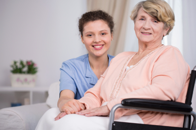 caregiver and senior woman are smiling